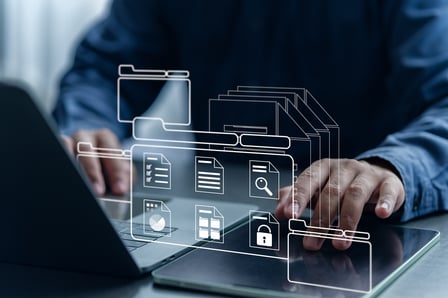 Brand Independence image of man on laptop and tablet with file organization seen