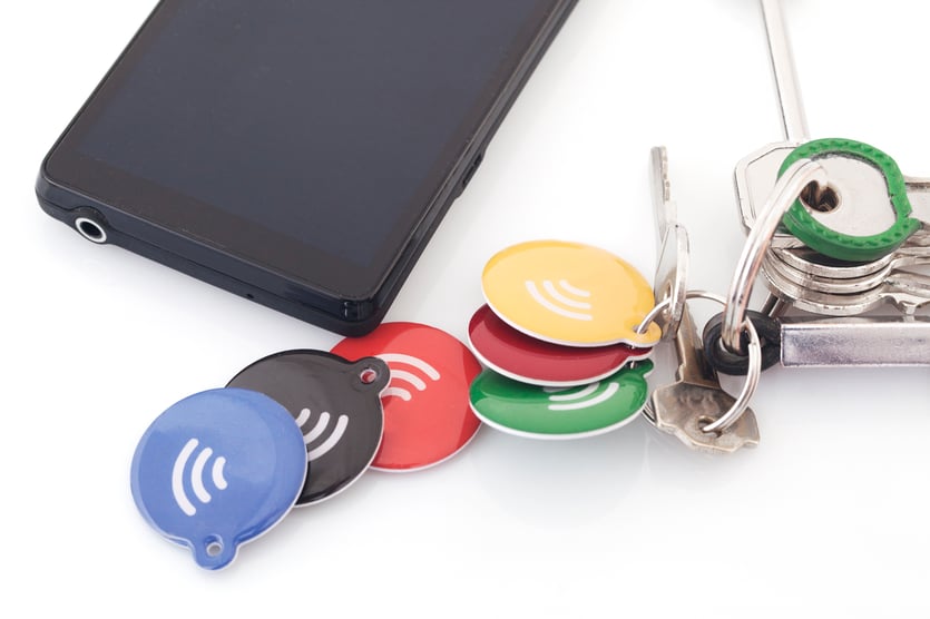 A variety of Credentials on a desk: fobs, phone, keys A variety of Credentials on a desk: fobs, phone, keys