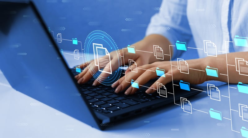 Hands on a laptop showing folders and Data Organization