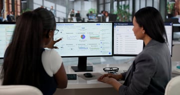 Security and Risk Leaders looking at metric dashboard on computer screen