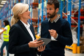 Male and Female Facilities managers looking at a tablet 