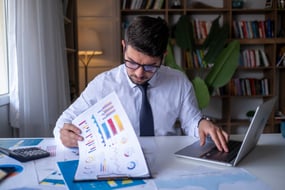 finance manager reviewing reports while on a laptop
