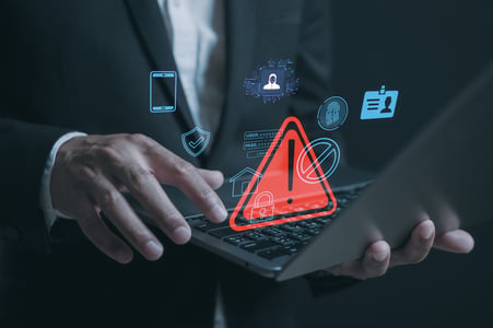 man holds laptop and visualizes risk factors 