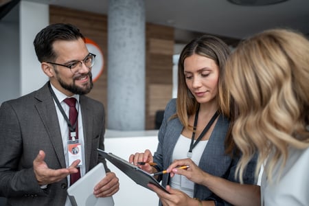 three co-workers coordinating handoffs and real-time credential visibility
