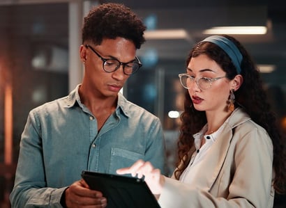 diverse staffers look at a tablet for instant look-ups on credential assignments and uses. 